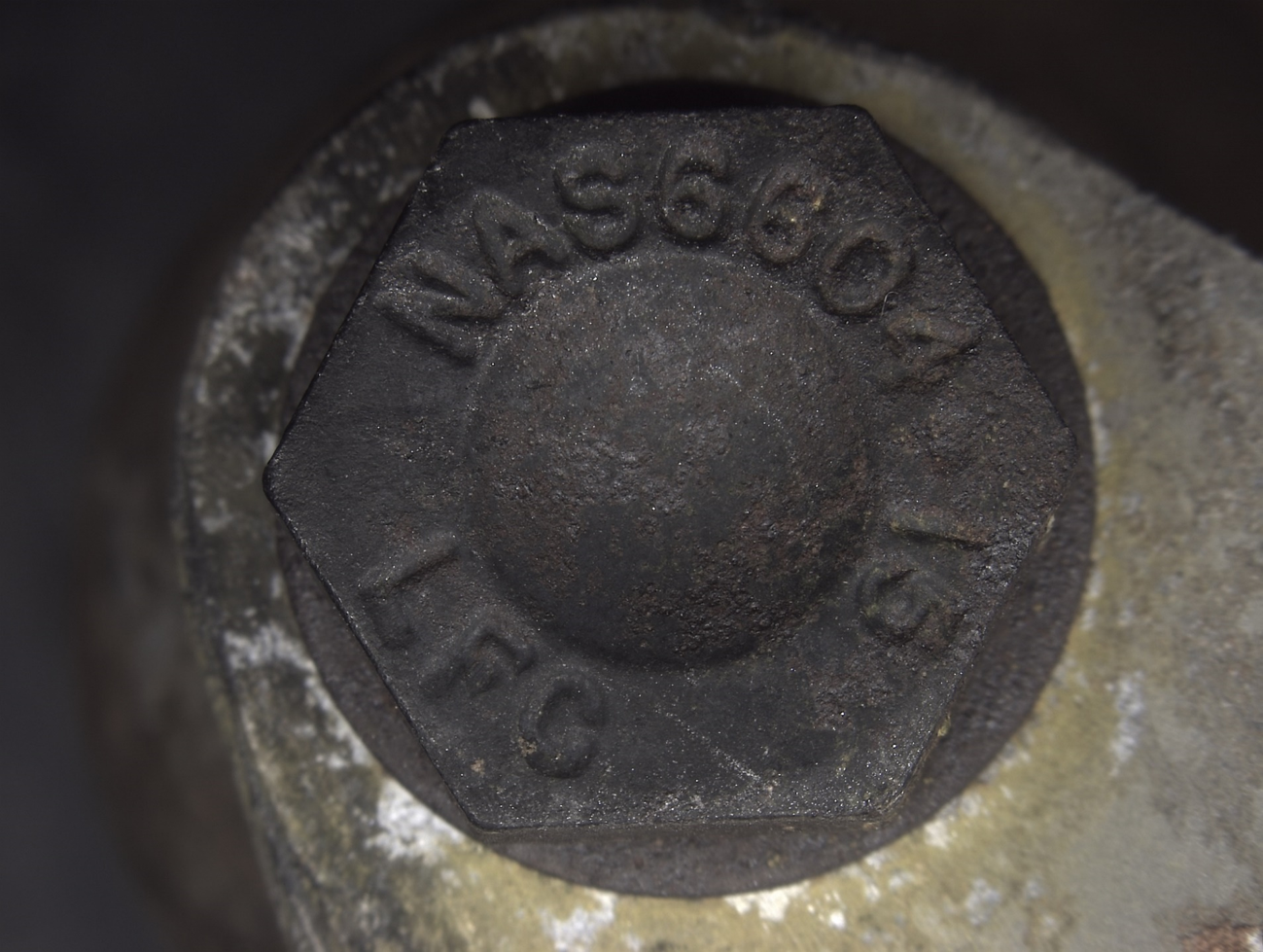 Figure A8: Bolt head markings from one of the remaining bellcrank bolts .