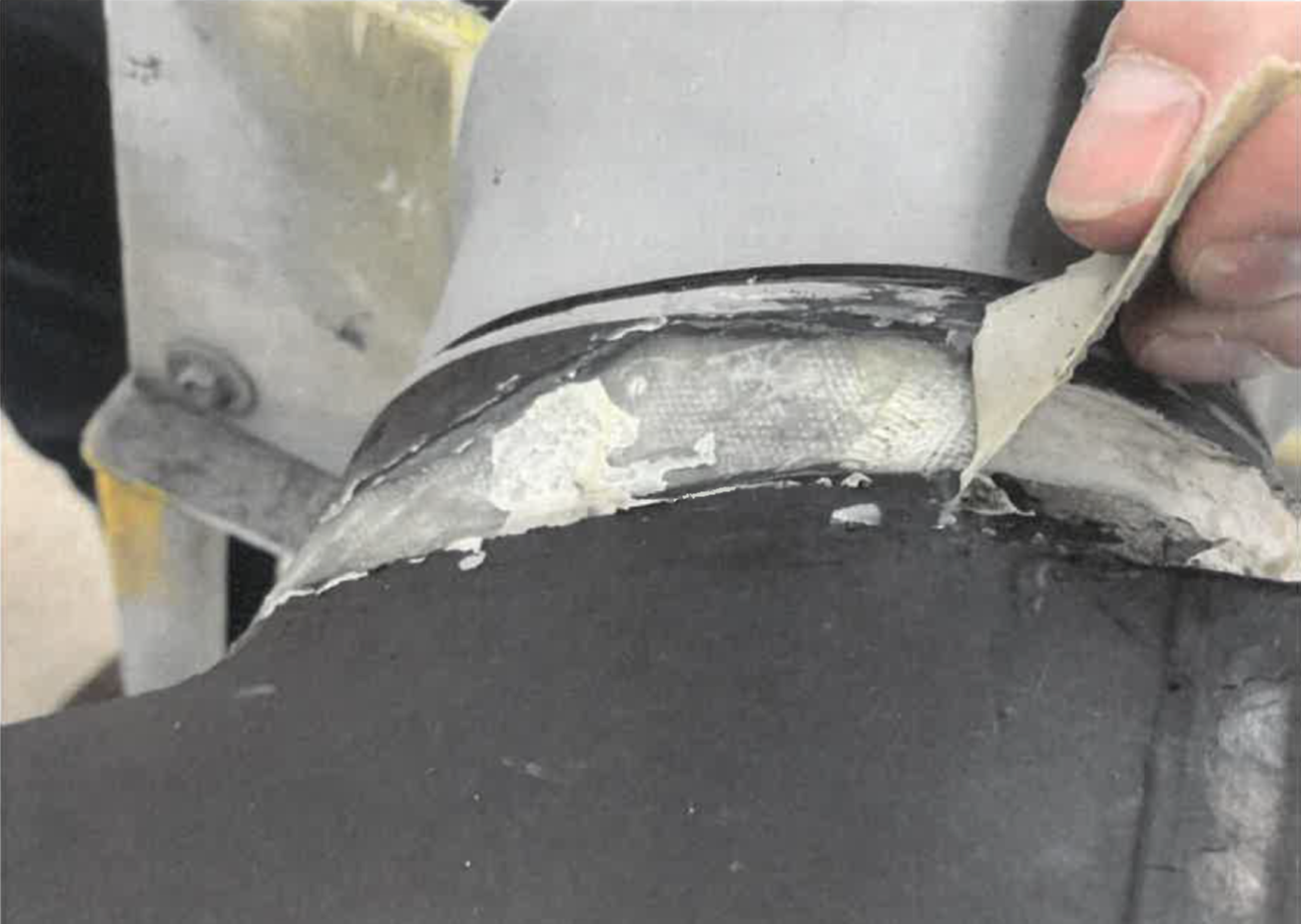 Figure 3: RTV157 adhesive being peeled off the number 2 blade shank.<br />
Source: Propeller repair vendor