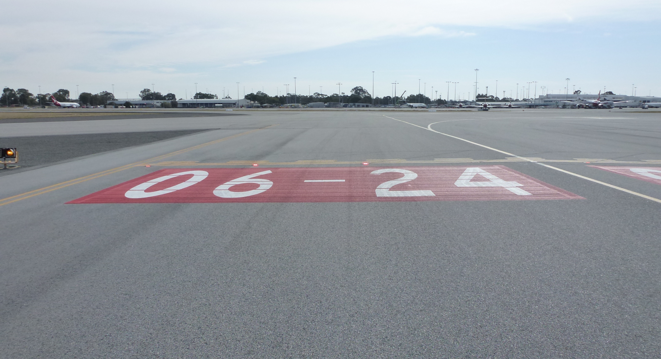 Figure 8: Runway identifier (red and white markings) and stop bar (red lights) installed on taxiway J2.Source: ATSB