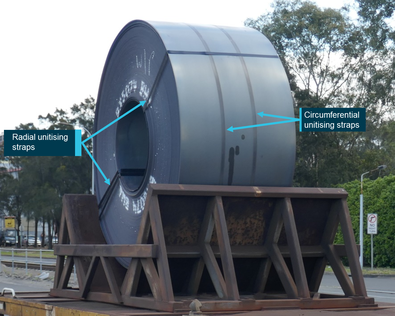 Figure 1: Jumbo coil fitted on a wagon within a cradle, showing radial and circumferential unitising straps.<br />
Source: ATSB