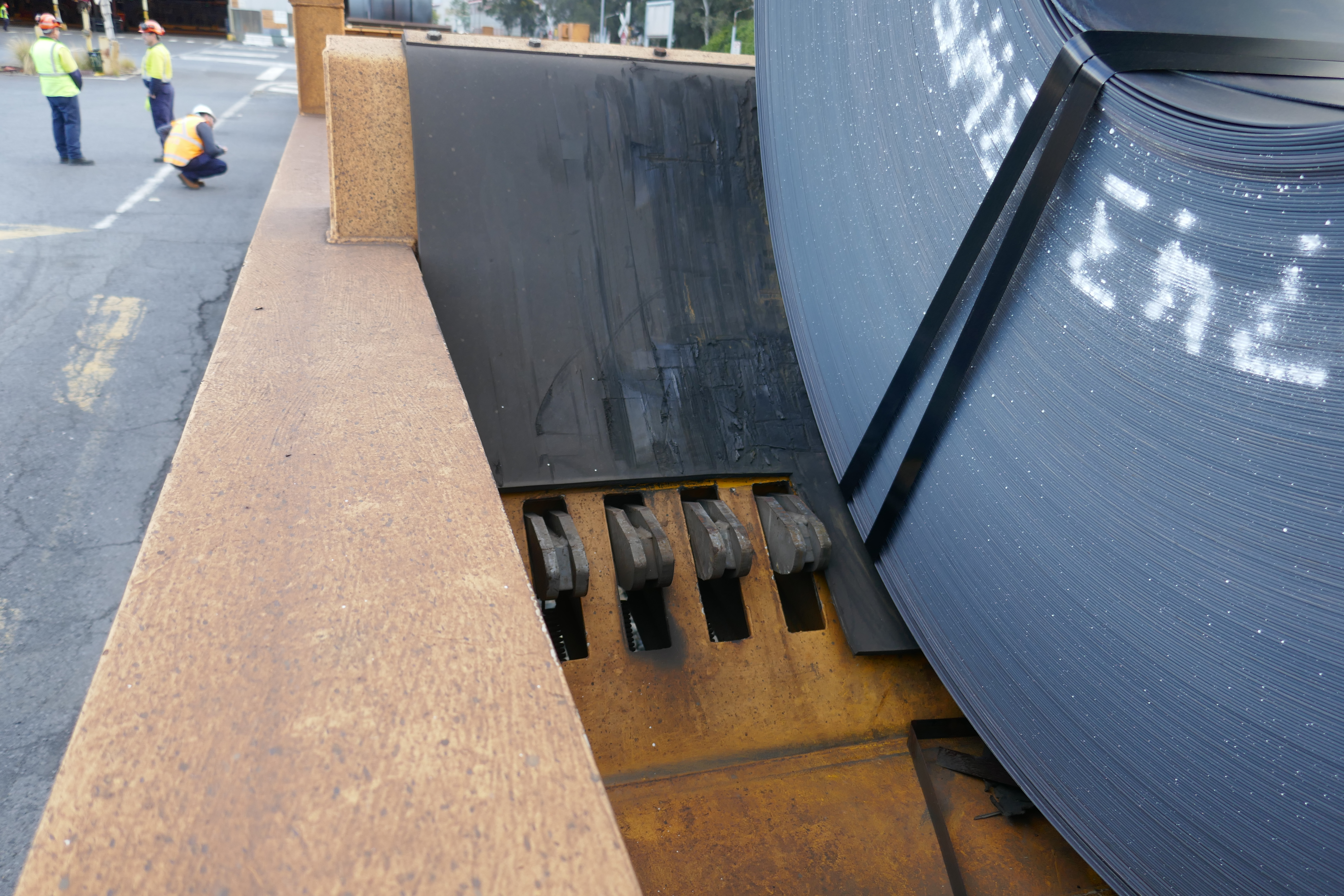 Figure 6: Coil cradle retractable fingers and their position relative to a loaded coil.
Note: The position of the radial steel straps are below the contact location with the slope face of the cradle.
Source: ATSB