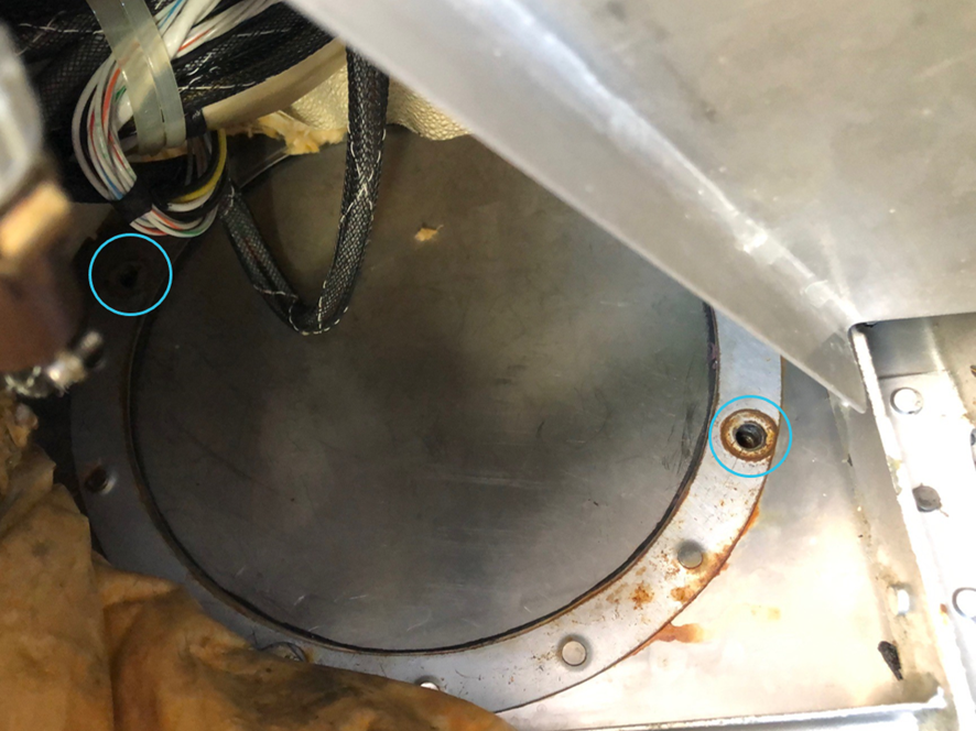 Magneto access panel on exemplar DHC-2 aircraft with two 4.76 mm diameter holes (circled) following bolt removal