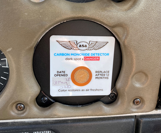 Slightly discoloured carbon monoxide detector, after engine shutdown and the detector being exposed to fresh air