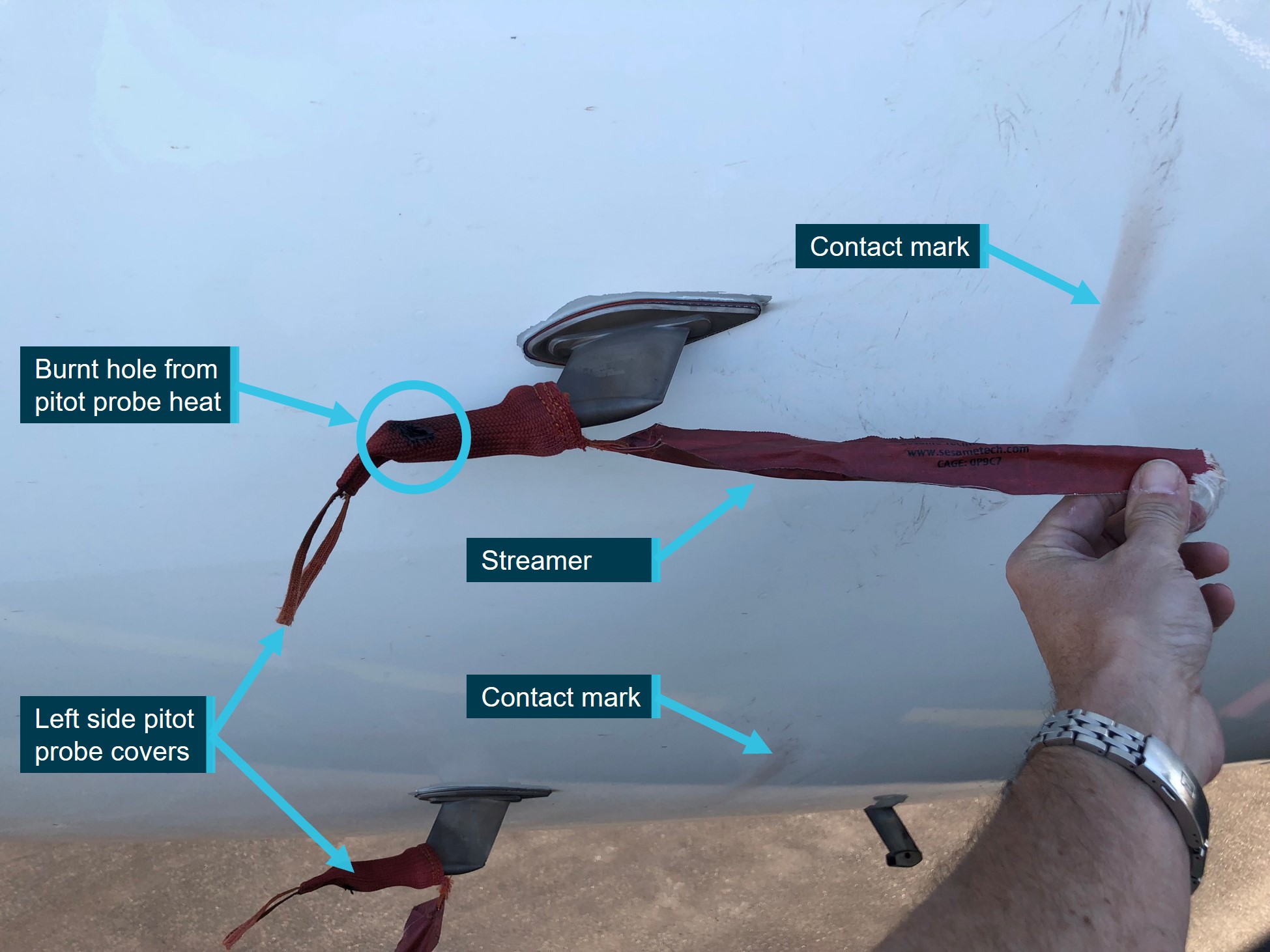 Reconstruction of pitot probe covers on 9M-MTK, showing pitot probe cover damage and contact marks on aircraft skin from the streamer