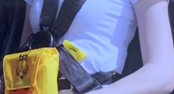Passenger wearing a pouch-style constant wear lifejacket and multipoint seatbelt