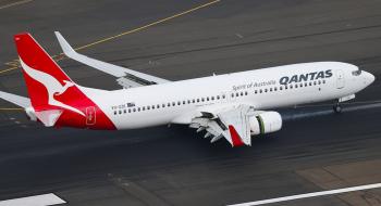 Qantas Boeing 737-800 (VH-XZK) on the ground at an airport.