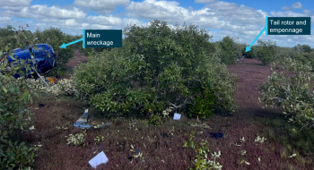 Photograph of main and tail rotor wreckage at accident site