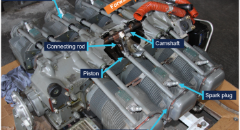 View of the engine showing the large hole in the crankcase behind the number 4 cylinder, with the number 4 connecting rod protruding from the hole.