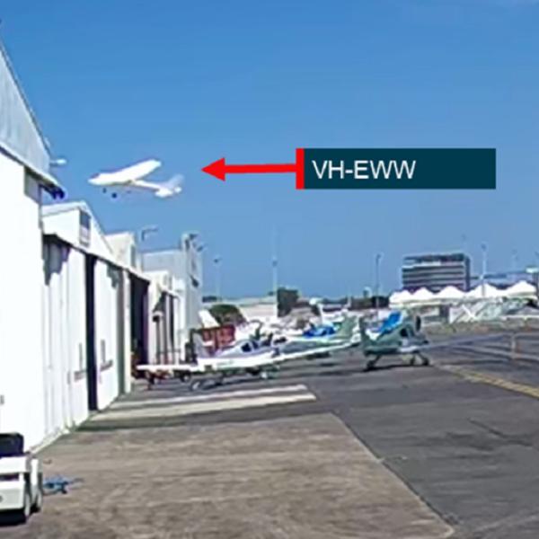 Image from CCTV footage showing VH-EWW passing close above hangars