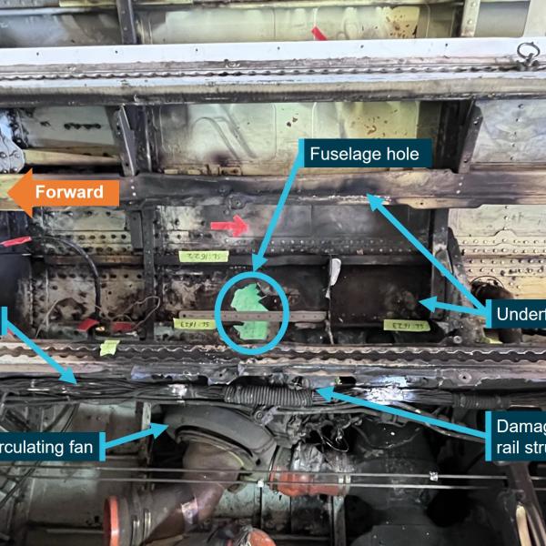Underfloor fire damage showing fuselage hole