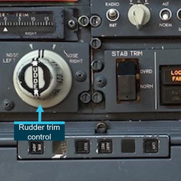 Rudder trim and door lock switch on the aisle stand of a Virgin Australia B737 aircraft.