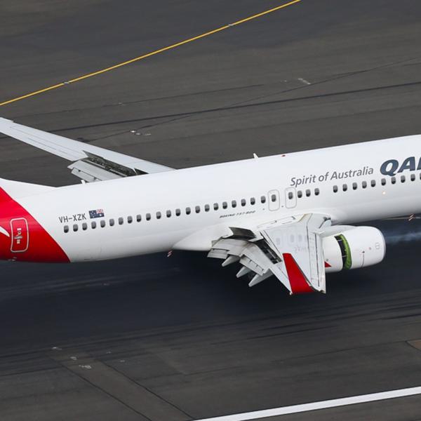Qantas Boeing 737-800 (VH-XZK) on the ground at an airport.