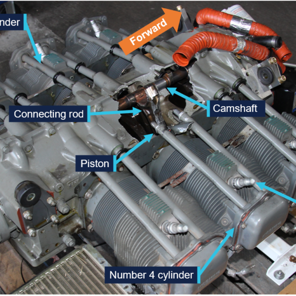 View of the engine showing the large hole in the crankcase behind the number 4 cylinder, with the number 4 connecting rod protruding from the hole.
