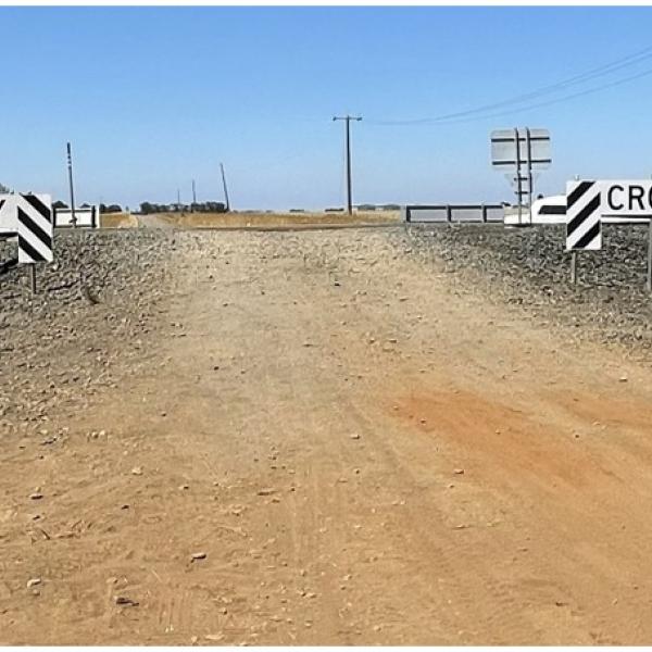Photograph of the road vehicle approach to the crossing from the north along the unsealed road.