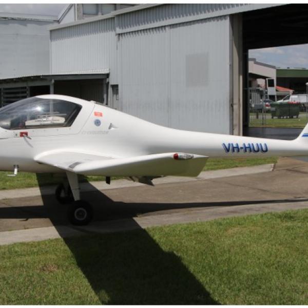 Aircraft VH-HUU in front of a hanger