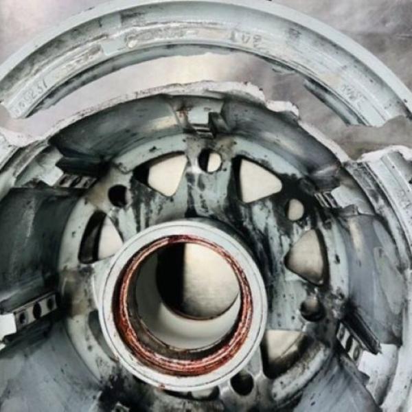 Fractured inner rim section of main landing gear wheel.