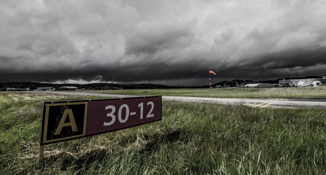 Stormy clouds over an airport and runway.