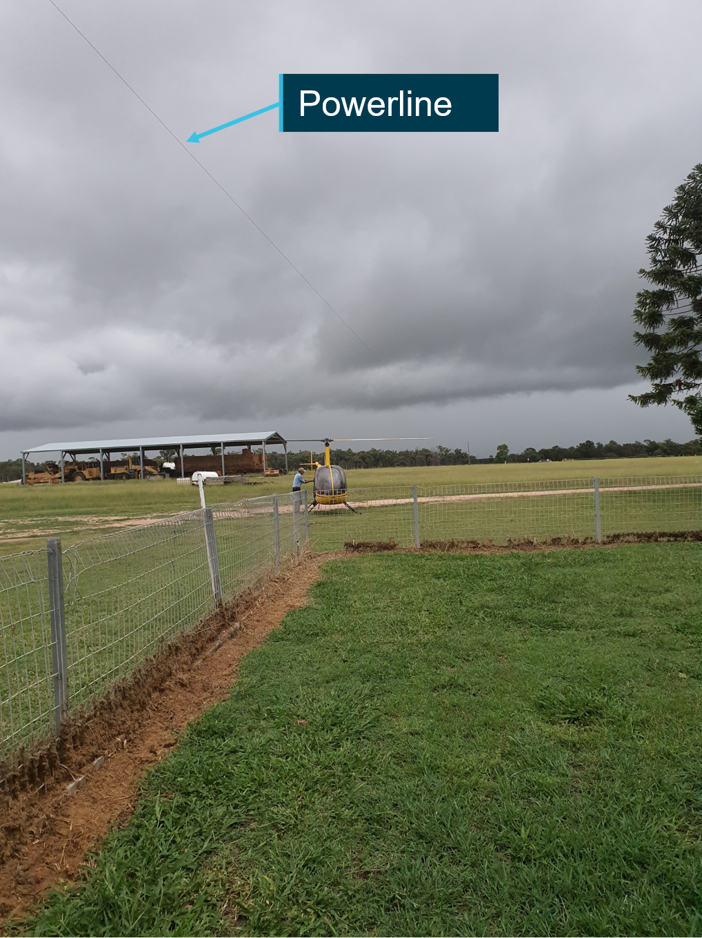 Figure 1: Photo from 1829 EST - VH-HKC and pilot following arrival at Camden Park Station, property powerline indicated and southerly cloud conditions visible