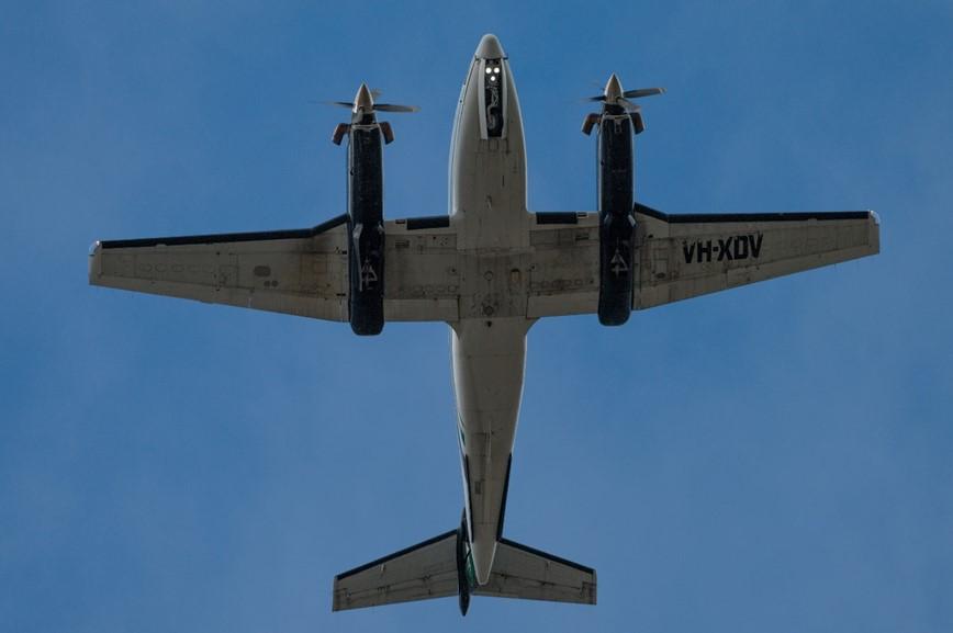 Figure 1: VH-XDV with landing gear partially retracted as it overflew Williamtown Airport
