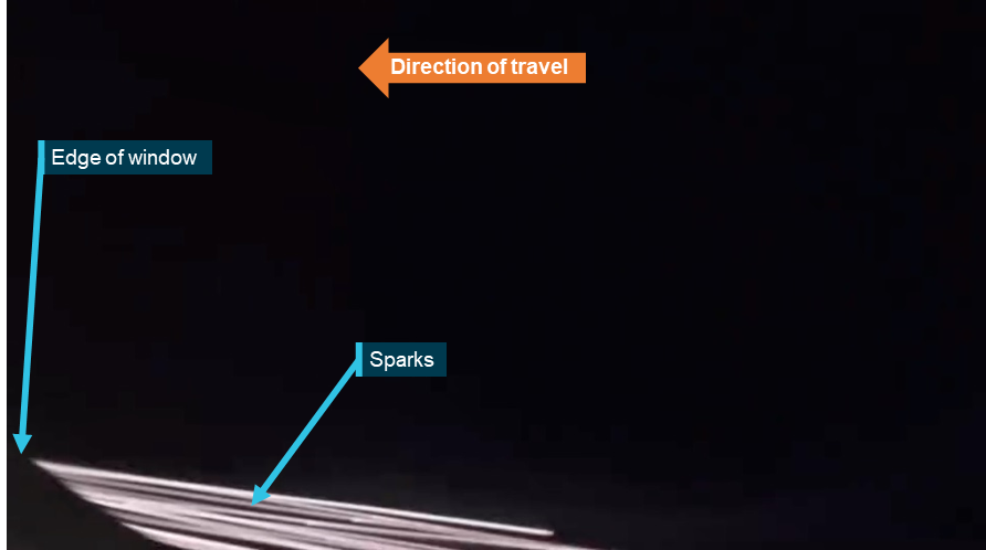 Still image from passenger video capturing sparks emanating from right engine during climb