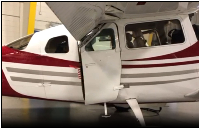 Cessna 206 with approved forward cargo door. The hinged door allows the top of the door to fold underneath the flap when extended in any position.