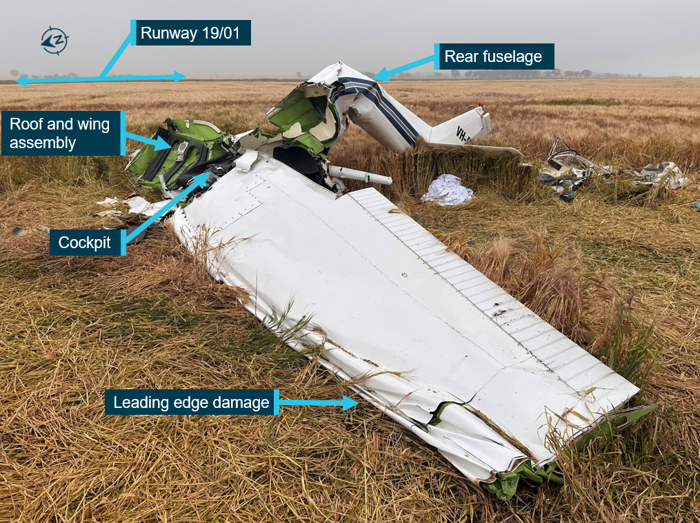 View of VH-EYU wreckage, highlighting the wing, fuselage and cockpit damage. 