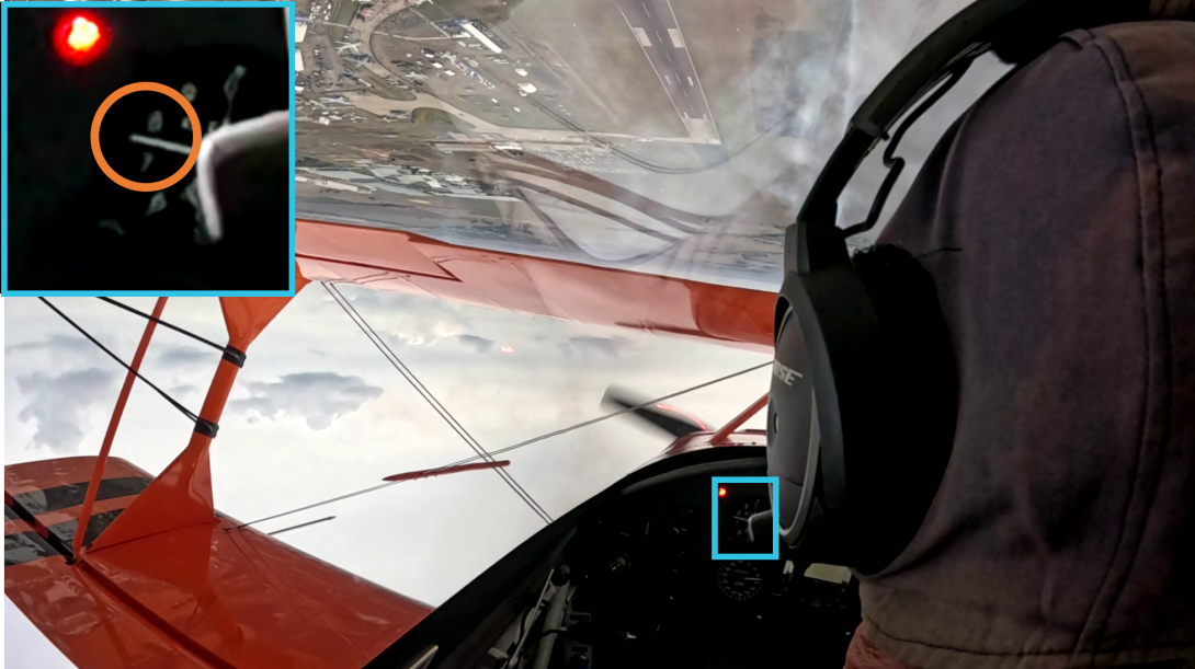 A still image taken from the onboard camera. The image highlights the altitude indicator instrument showing 700–800 ft just prior to the snap rolls.