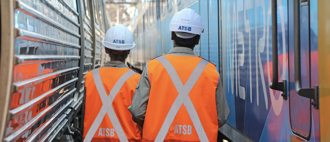 Two investigators looking at train wreckage