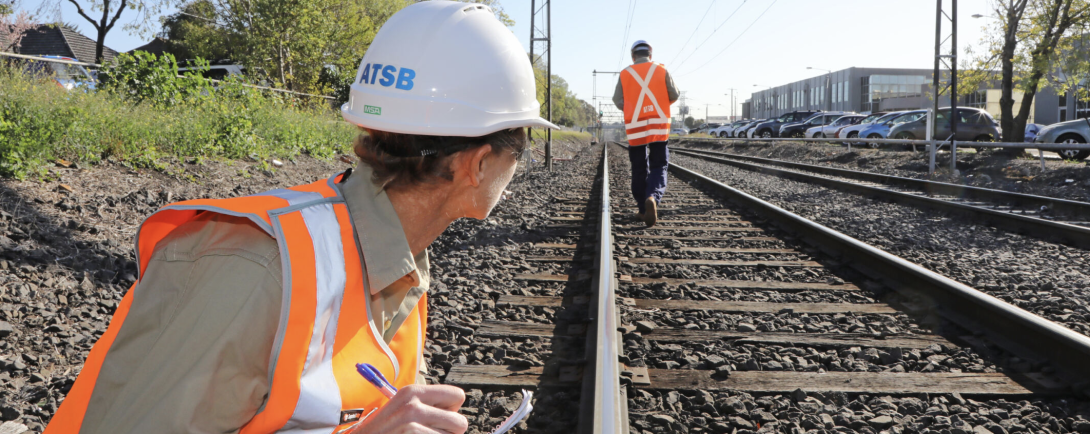 Rail investigator taking notes at an accident site.