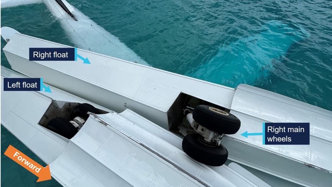 Image of overturned aircraft, post-accident, showing left main gear retracted into the float and right main gear extended.