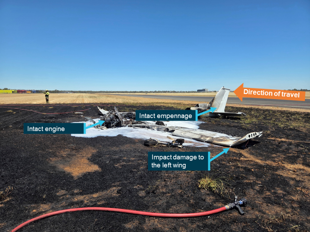 Aircraft to the left of the runway destroyed by fire. 