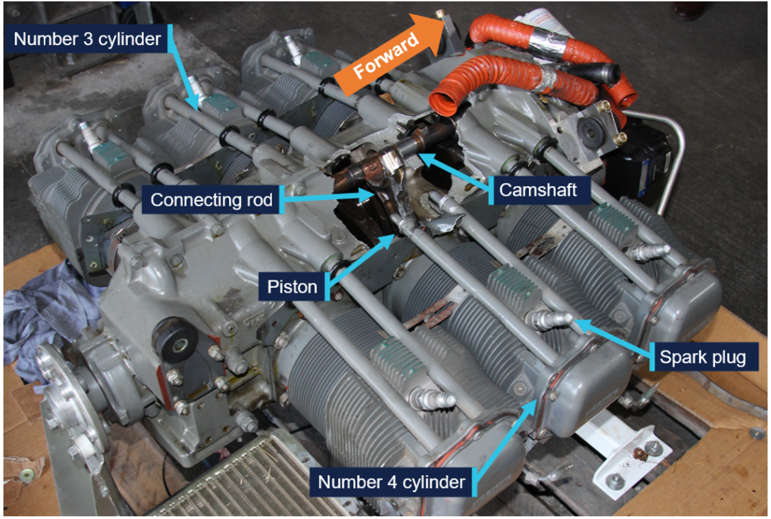 View of the engine showing the large hole in the crankcase behind the number 4 cylinder, with the number 4 connecting rod protruding from the hole.